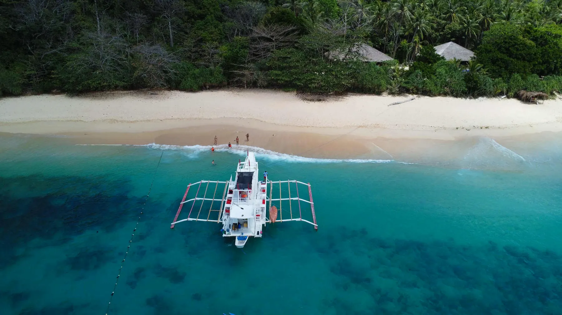 Outrigger boat in turquoise water