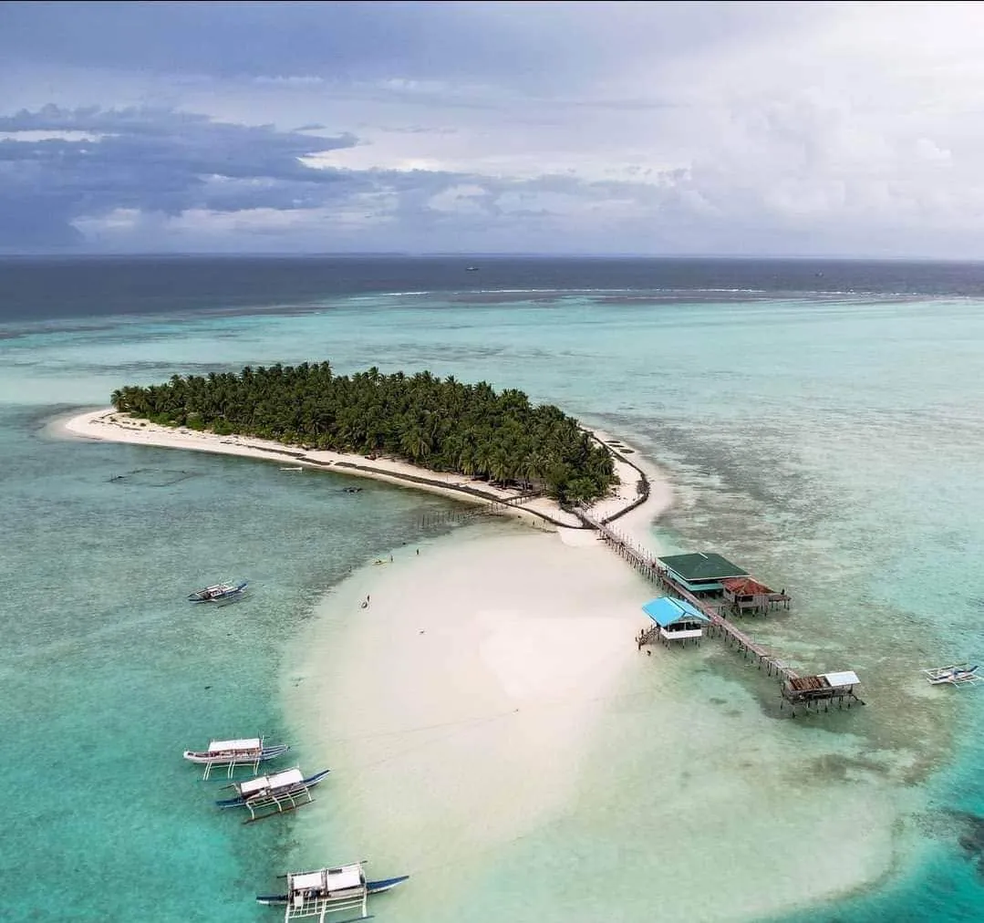 Aerial view of Onok Island in Balabac, with its palm grove, white sandbar and wooden pier