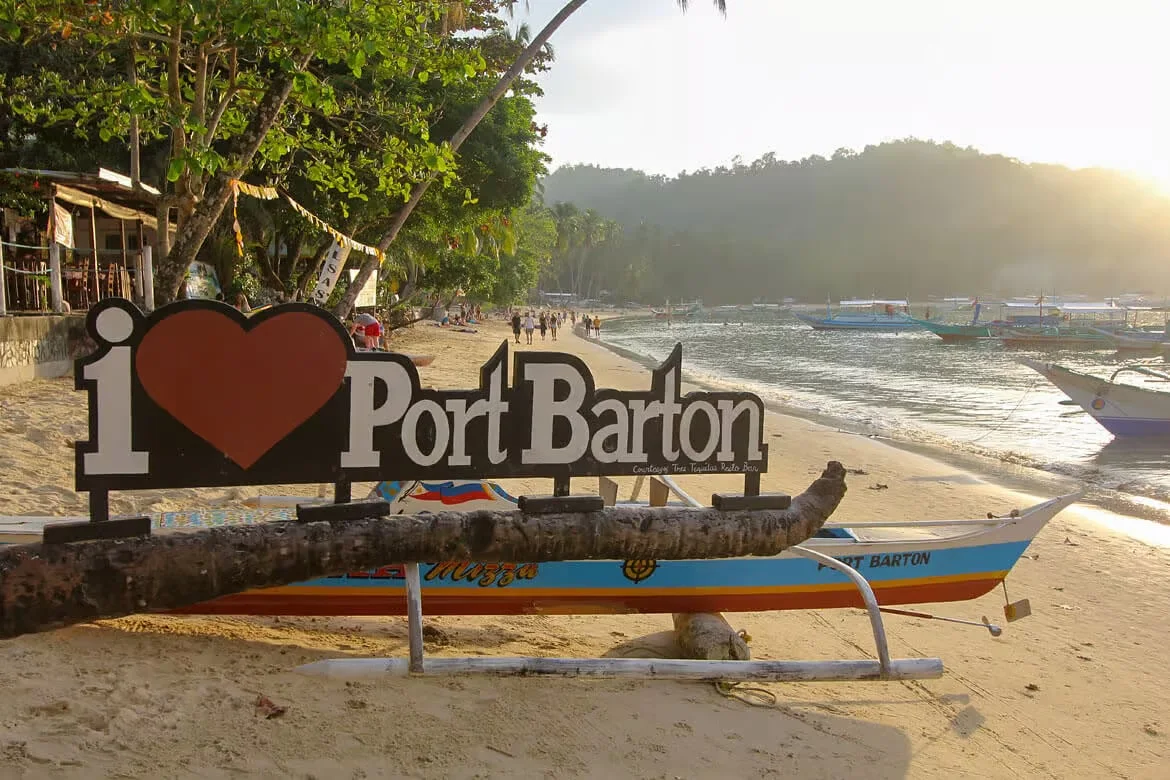 The I love Port Barton sign on the beach at golden hour